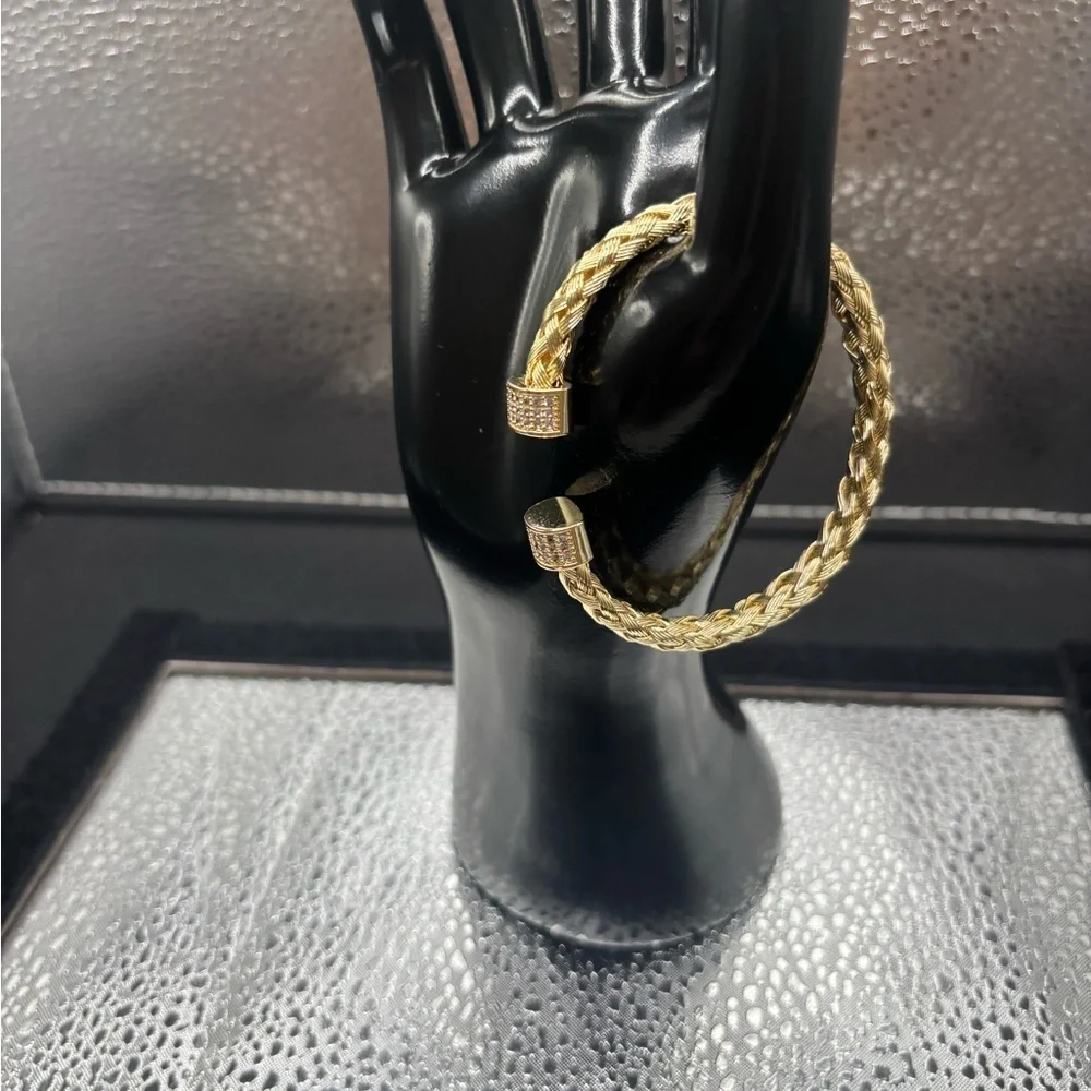 Elegant Gold Braided Also Adjustable Bangle .